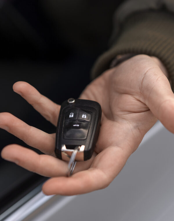 high-angle-hand-holding-car-key