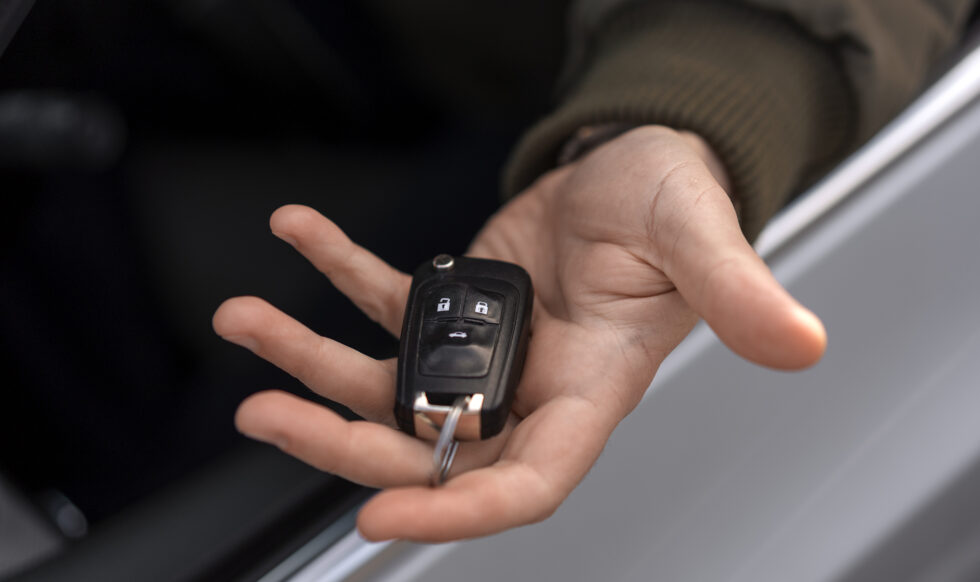 high-angle-hand-holding-car-key